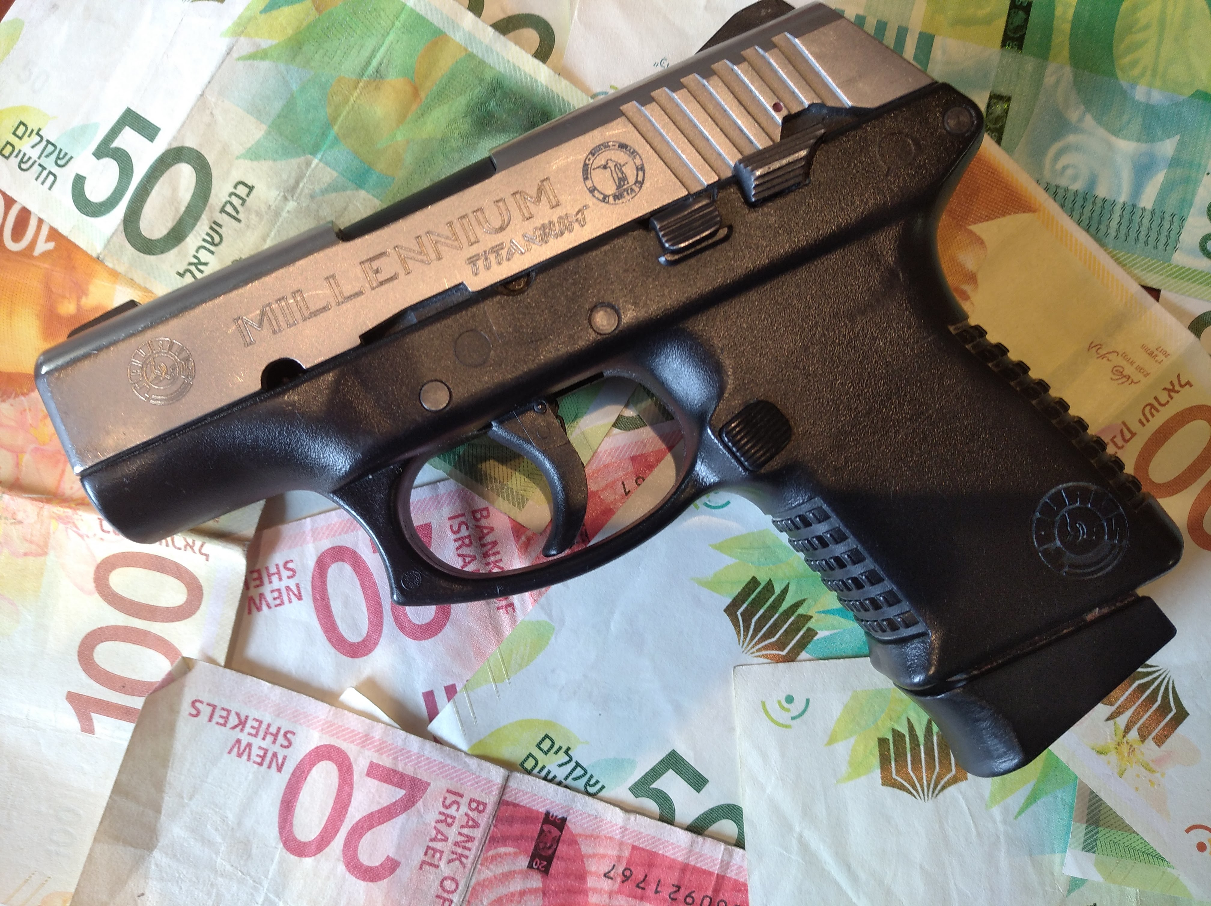 Gun placed on cash: Illustration