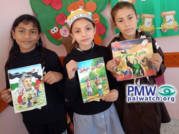 Girls holding terrorist pictures