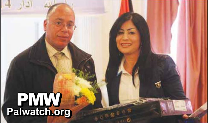 Photo: Journalist Manal Seif accepts the [Palestinian] Woman Media Award.